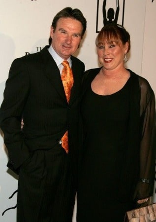 On the left side Patti McGuire wearing black dress and on the right side Jimmy Connors attending award show.